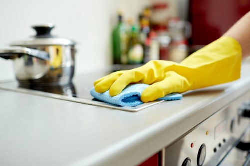 Technician performing oven cleaning in W13 on a built-in oven